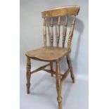 A late Victorian beech kitchen chair with concave cresting rail, turned spindles and bordered elm