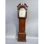 A George III oak long case clock with broken swan neck pediment, the arched enamel dial painted with