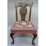 A George III style mahogany dining chair with pierced vasular splat beneath a serpentine cresting