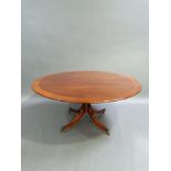 A reproduction mahogany Regency style circular dining table by William Tillman, the circular top