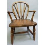 A child's oak rail back chair, serpentine arms, on turned legs with 'H' stretcher, 63cm height at