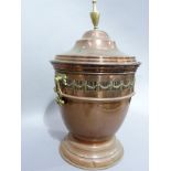 An early twentieth century copper and brass coal vase having a domed cover with urn finial, the body