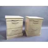 A pair of reproduction wood effect bedside chests fitted one shallow and two deep drawers, 48cm