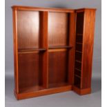 A reproduction mahogany L-shaped book case in George III style with flared cornice, adjustable