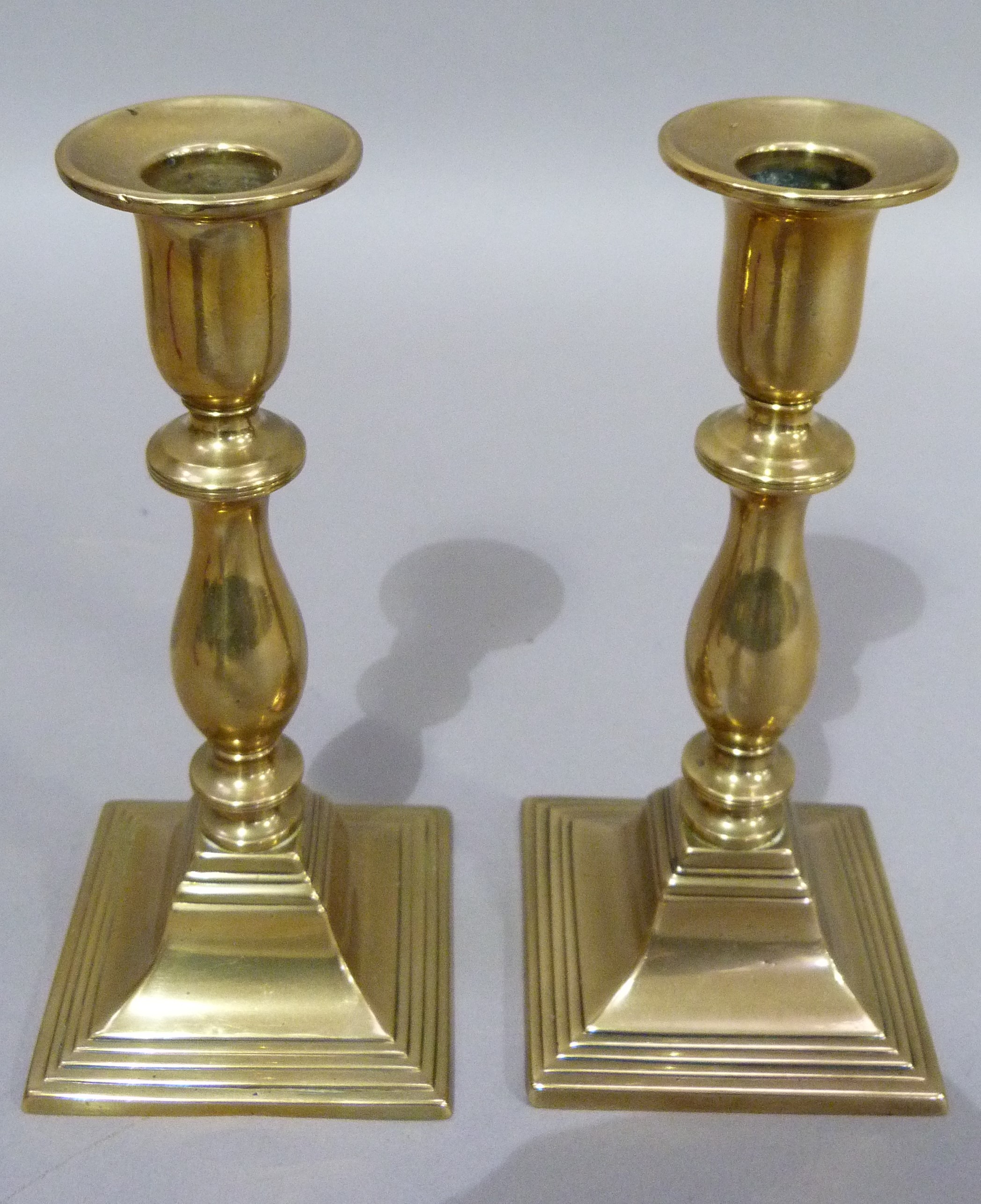 A pair of nineteenth century brass candlesticks of baluster outline on square stepped bases, 19cm - Image 3 of 4