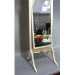 A white painted wooden cheval mirror in Queen Anne style with arched plate on square uprights and