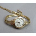 A lady's manual wristwatch c.1958 in 9ct gold sunburst case No. 70383, manual jewelled lever