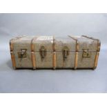 A vintage metal and wooden bound canvas trunk with leather handles, 93cm wide, 34cm high