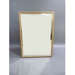 A reproduction gilt framed wall mirror with stepped frame with fluted border, bevelled plate,