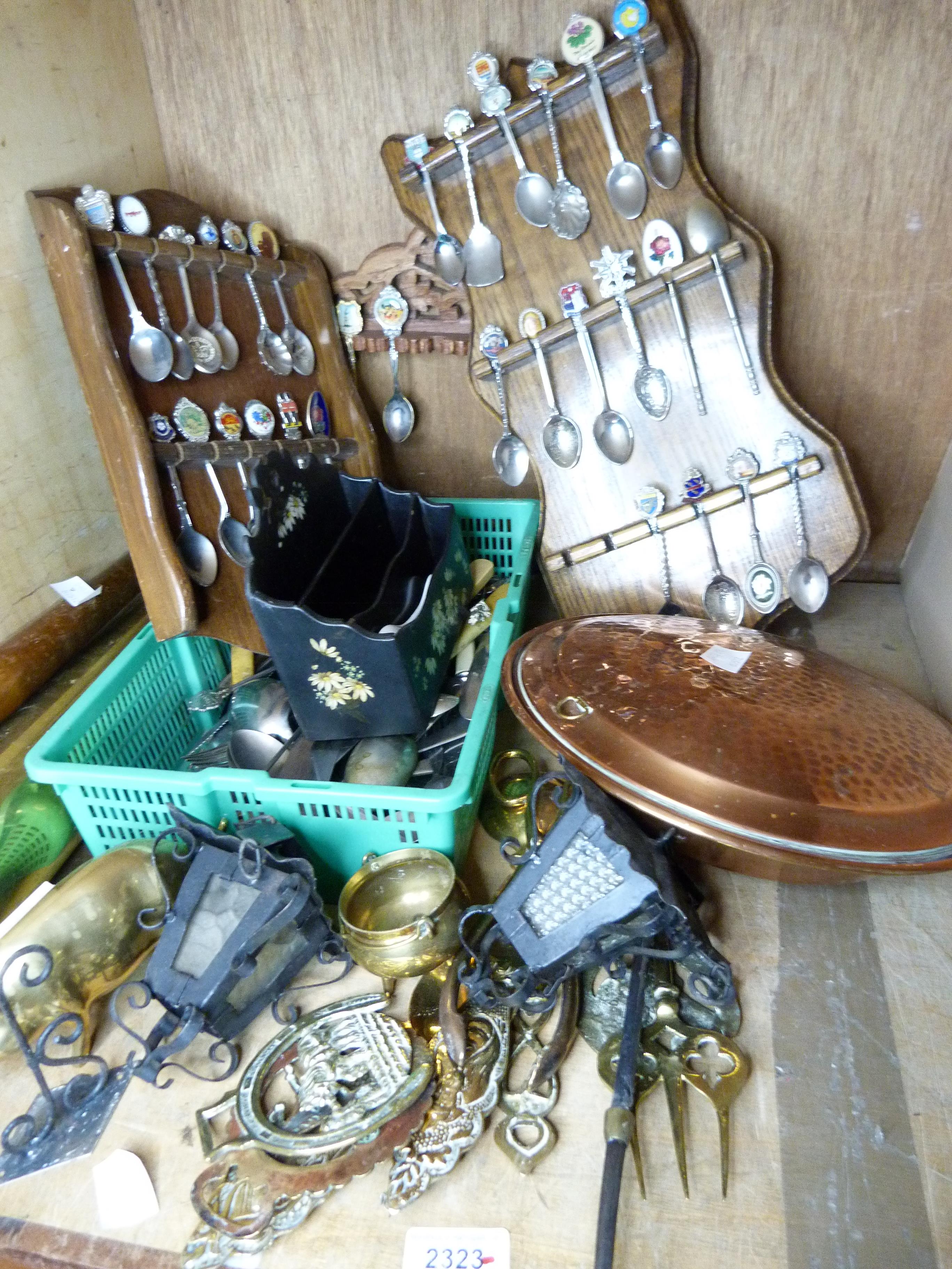 A small quantity of silver plated commemorative spoons contained within shaped oak racks, together