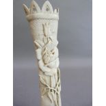 A bone carving of a castle turret with rose briar, the reverse with cartouche and Isle of Man