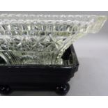 An Art Deco moulded black and clear glass flower vase and stand of square outline