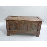 A late seventeenth century oak three panel blanket chest, the hinged top above a carved frieze and