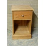 A reproduction pine bedside cabinet with frieze drawer and open compartment, skirted plinth, 48cm