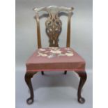 A George III style mahogany dining chair with pierced vasular splat beneath a serpentine cresting