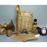 A wicker basket by Chairworks, Chelsea Bridge London, together with a yew wood carved apple and a