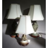 A pair verdigris metal table lamps of pierced foliate vase form on hardwood stands together with a