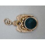 A Victorian bloodstone and onyx spinning watch fob in 9ct rose gold, the circular stones collet