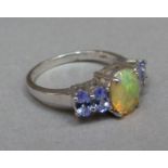 An opal and tanzanite five stone ring in silver, the oval facetted stones set in line