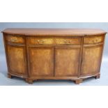 A reproduction mahogany sideboard in George III style, the break-front top with cross grained border