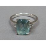 An aquamarine and cubic zirconia ring claw set in silver