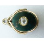 A Victorian bloodstone and cornelian novelty spinning watch fob in rolled gold, set to the centre of