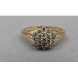 A diamond cluster ring in 18ct gold, the brilliant cut diamonds tiered and claw set within a