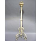 A late nineteenth century/early twentieth century cream painted standard oil lamp, with reservoir on