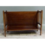 An early 20th century mahogany book stand having a plain panel back, railed sides on square framing,