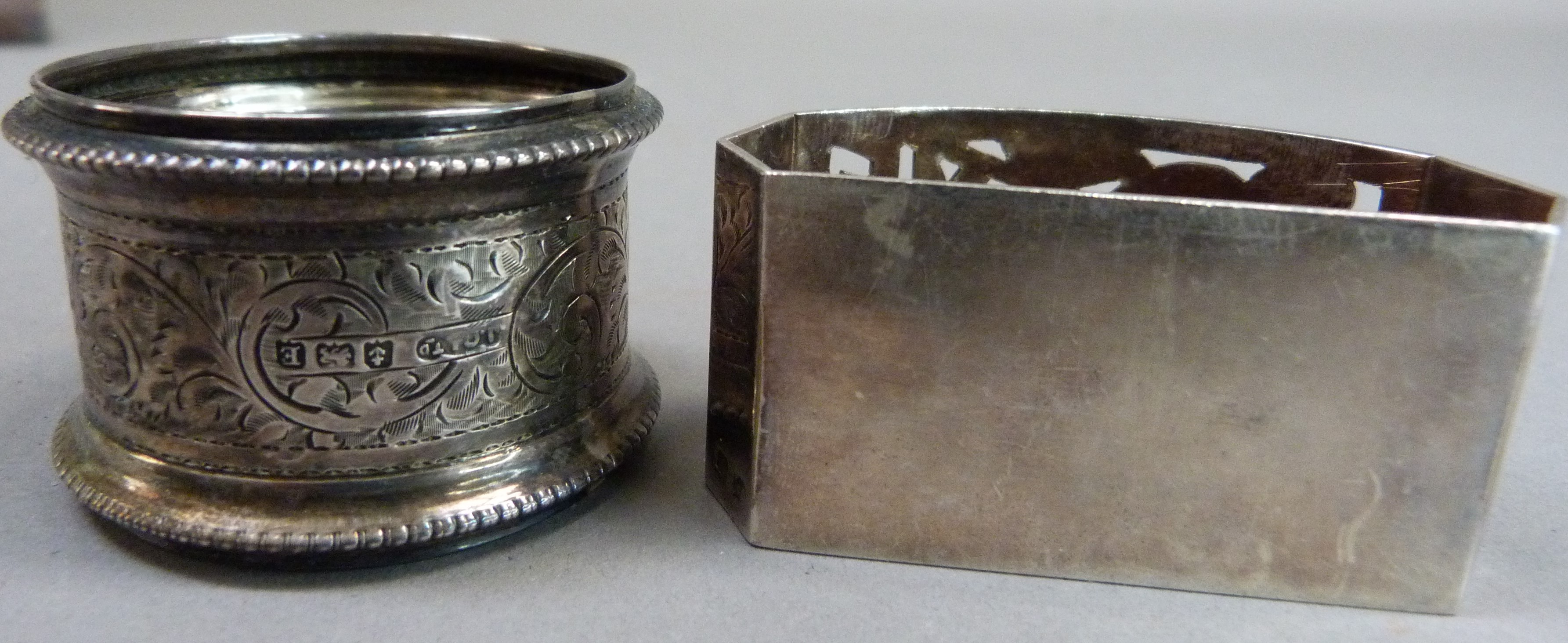 A silver napkin ring engraved with foliate leaf curls, with initial together with a white metal - Image 4 of 4