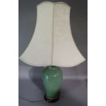 A chinoiserie green crackle glaze table lamp of vase form on hardwood stand, 48cm to fitting