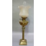 A Edwardian oil lamp with Corinthian column, opaque shade and brass reservoir on square stepped