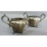 A silver cream jug and two handled sugar bowl on paw feet each initialled 'M', Sheffield 1905,