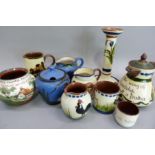 A quantity of Torquay ware, the cream brown ground variously decorated with cottages, cockerels