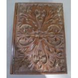A walnut box in the form of a book, the cover carved in low relief with thistles, 25.5cm by 19cm