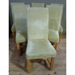 A set of six beech dining chairs having high backs upholstered in pale green velour fabric to the