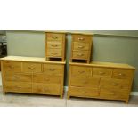A pair of reproduction oak chests each fitted with three short and four long drawers, 130cm wide