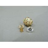 A pair of cubic zirconia ear studs and a polychrome enamel ear enhancer both in yellow metal (