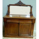 A Victorian mahogany chiffonier the mirrored back having a shield and foliate cresting, moulded