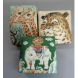 Three silk covered boxes each with petit point covered lids depicting giraffes, leopard and an