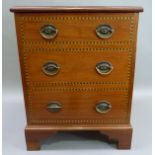 A mahogany box having a lift up lid, the front inlaid with box and ebony as three dummy drawers with