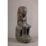 AN EGYPTIAN CARVED STONE FIGURE, seated with hands resting on his knees, 30cm high