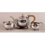 A THREE PIECE ARTS AND CRAFTS SILVER TEA SERVICE, Chester 1914, maker A. Edward Jones of circular