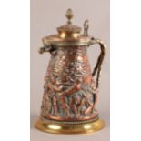 A LATE 19TH CENTURY COPPER AND BRASS LIDDED JUG, probably an electrotype, cast with a continuous