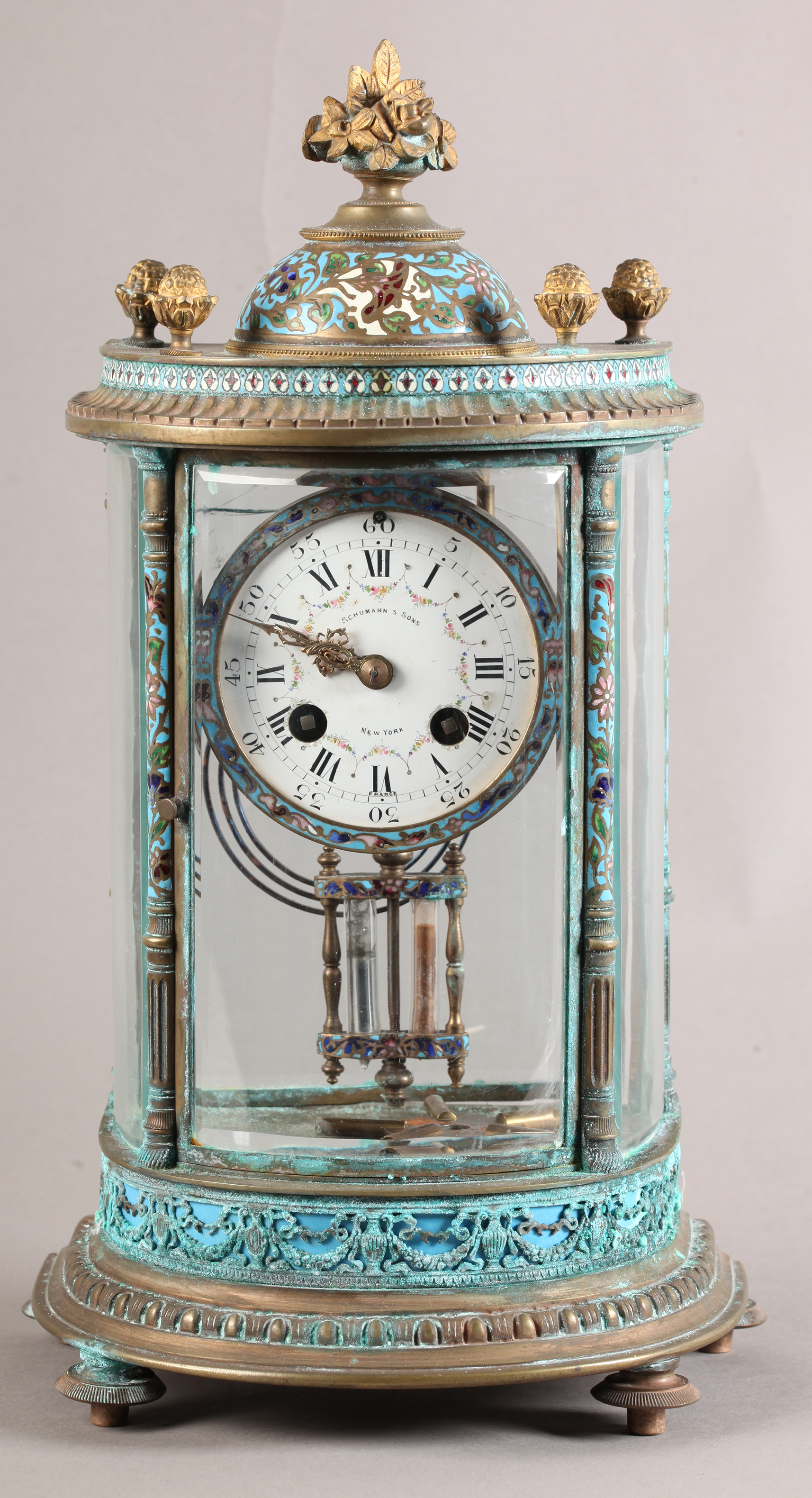 A FRENCH LATE 19TH CENTURY BRASS CASED AND CHAMPLEVE ENAMELLED FOUR GLASS MANTEL CLOCK, decorated