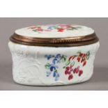 AN EARLY 19TH CENTURY GERMAN ENAMEL BOX, oval, the cover and sides painted with flowers, the white