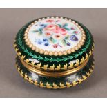 A 19TH CENTURY FRENCH GREEN ENAMEL BOX, circular, the cover painted with flowers on a white