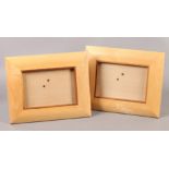 A PAIR OF LINLEY SYCAMORE AND ROSEWOOD BANDED CUSHIONED PHOTOGRAPH FRAMES, rectangular, 26cm x 21.