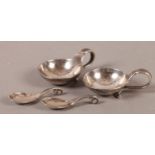 A PAIR OF DANISH .830 SILVER PLANISHED SALTS AND SPOONS, the strapwork handle terminating in