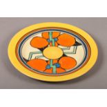 A CLARICE CLIFF 'RED FLOWER' PATTERN PLATE, circa 1930's, circular, painted in orange, yellow, green